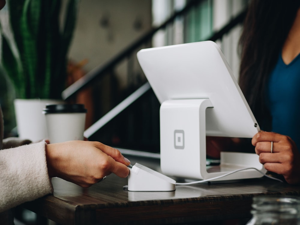A card reader ready on a cafe counter