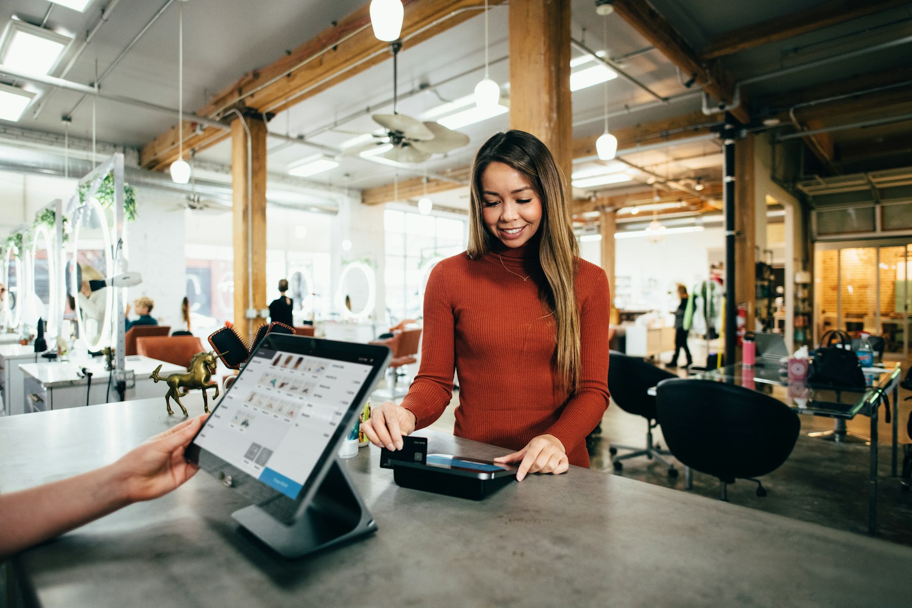 A shop owner taking a card payment